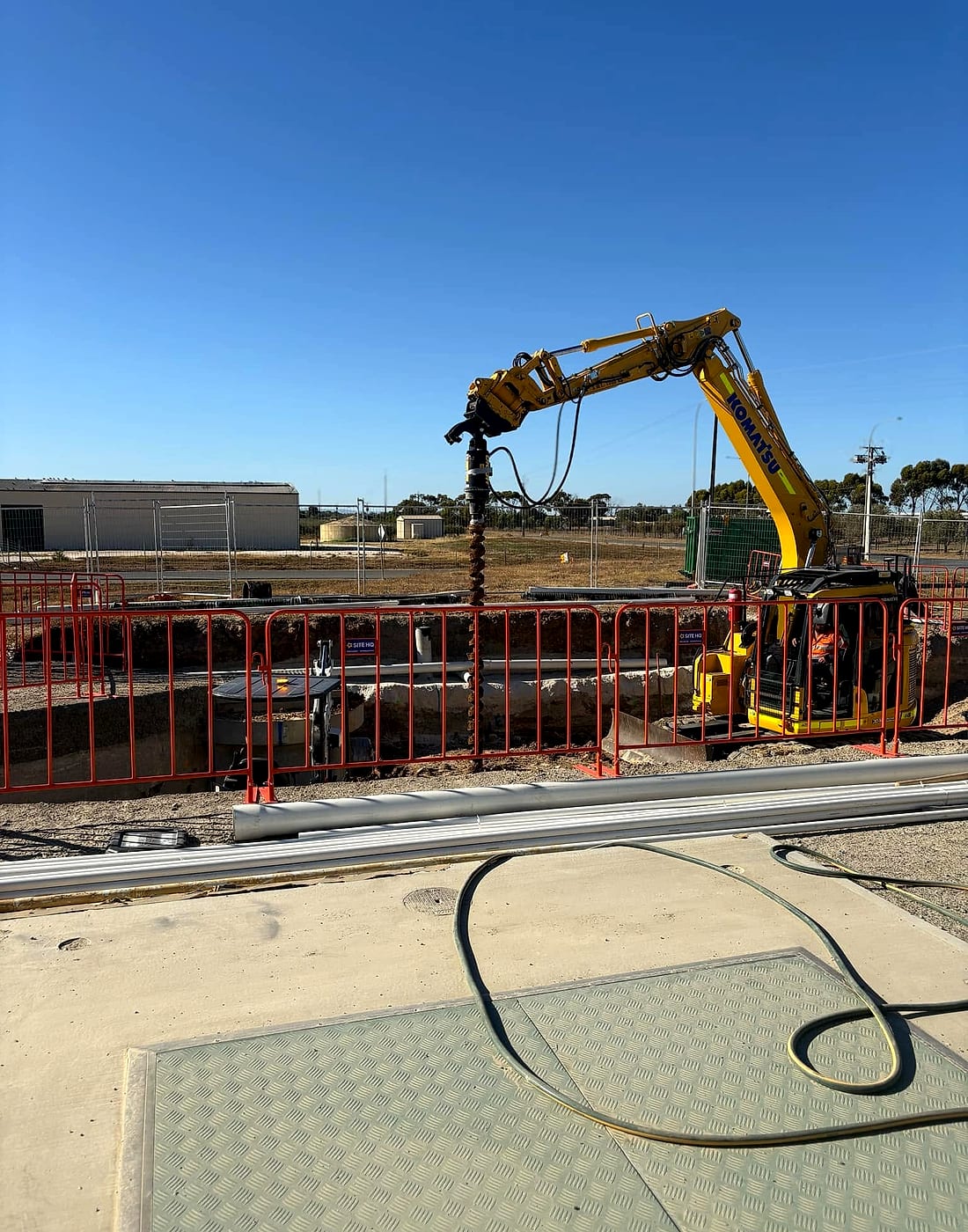 Excavator working on a sewer and water infrastructure site