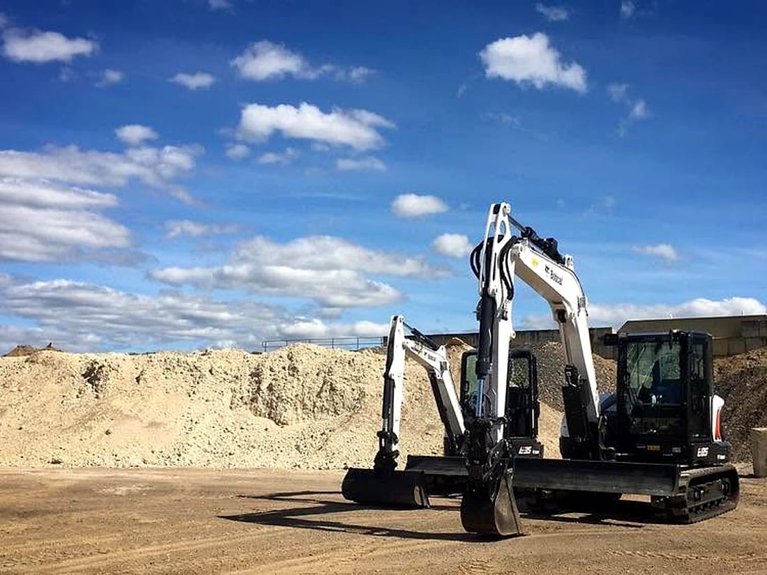 Excavator carrying out bulk earthworks and trenching